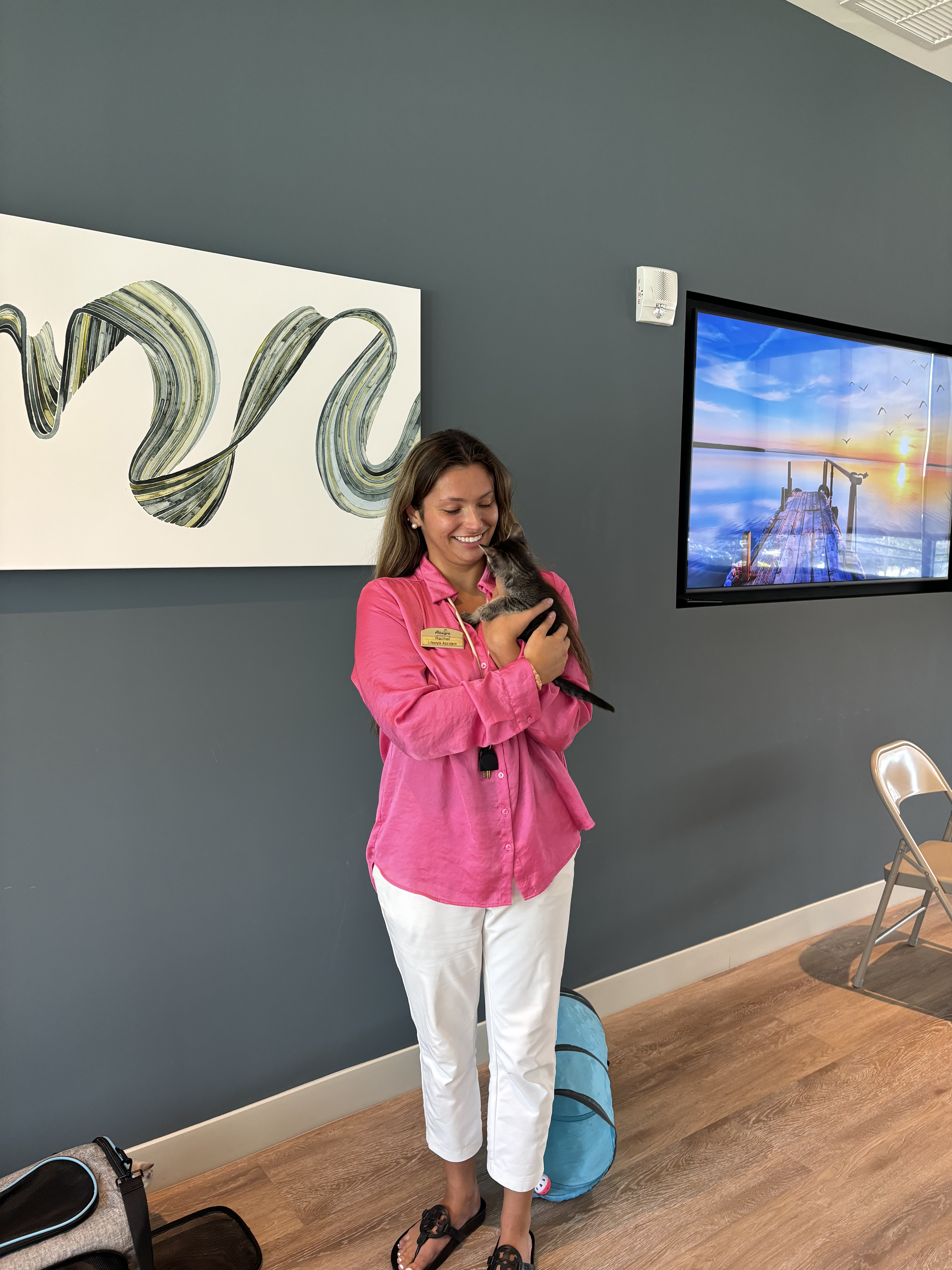 Happy participant cuddling a kitten at pilates class